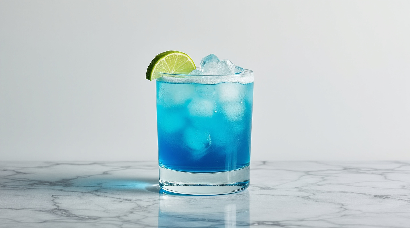 My Boy Blue cocktail in a glass with lime garnish